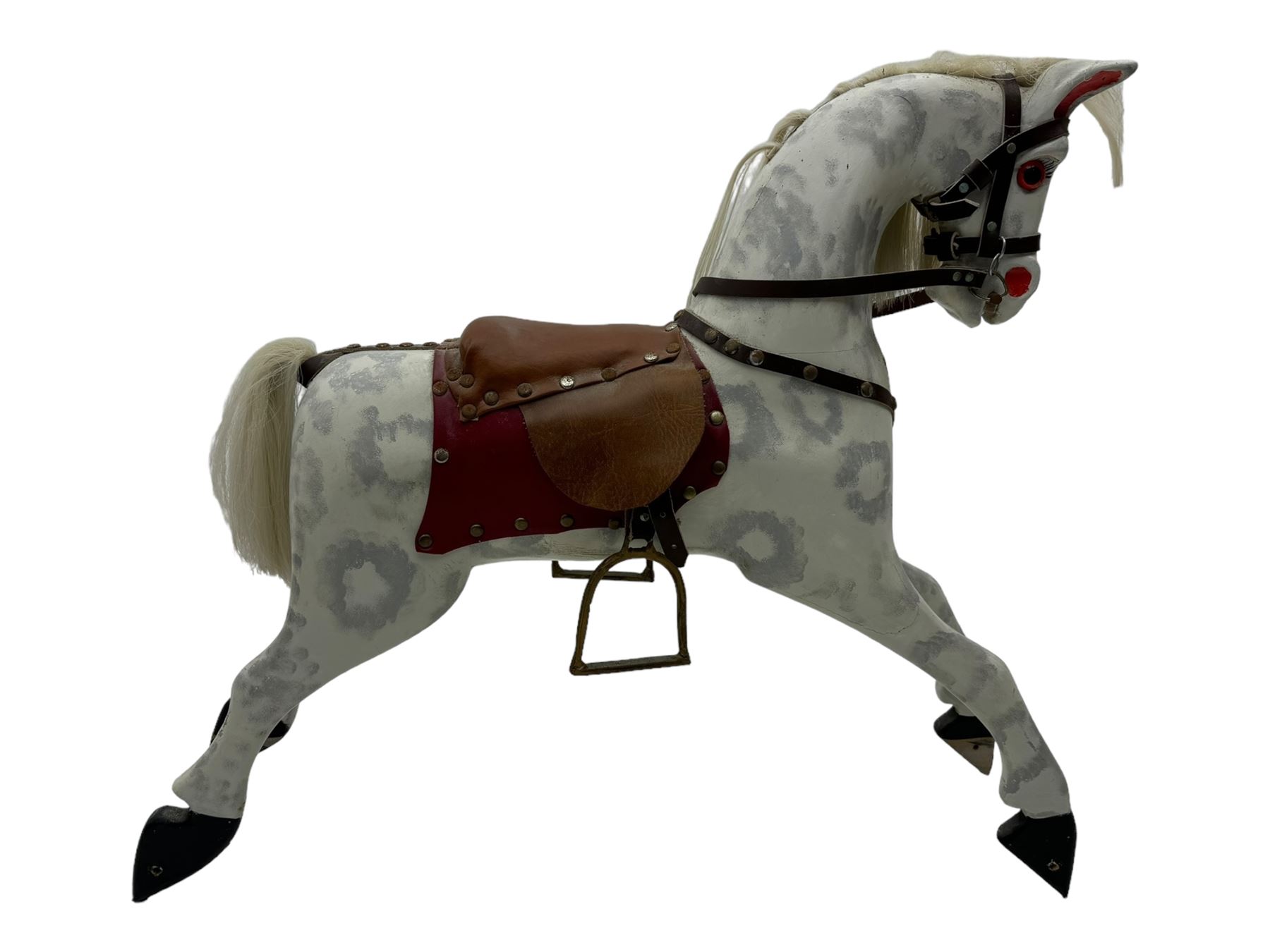 Mid 20th century rocking horse, dappled grey painted horse with applied mane and tail, red leather saddle and bridle accented with brass studs, supported by a stained wooden frame with turned supports and iron brackets, mounted on rockers