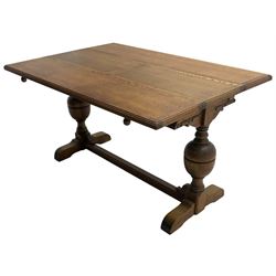 Early 20th century oak 'Ee-zi-Way one motion extending dining table', rectangular top over twin baluster end supports united by stretcher