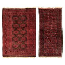 Turkoman red ground wool rug, the field with a repeating pattern of Tekke gul motifs in da...