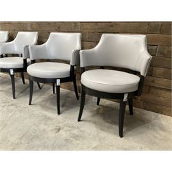 Four ebonised framed tub shaped armchairs, upholstered in grey fabric