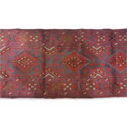 Meshwani crimson ground runner rug, the busy field decorated with four trailing lozenges surrounded by geometric motifs