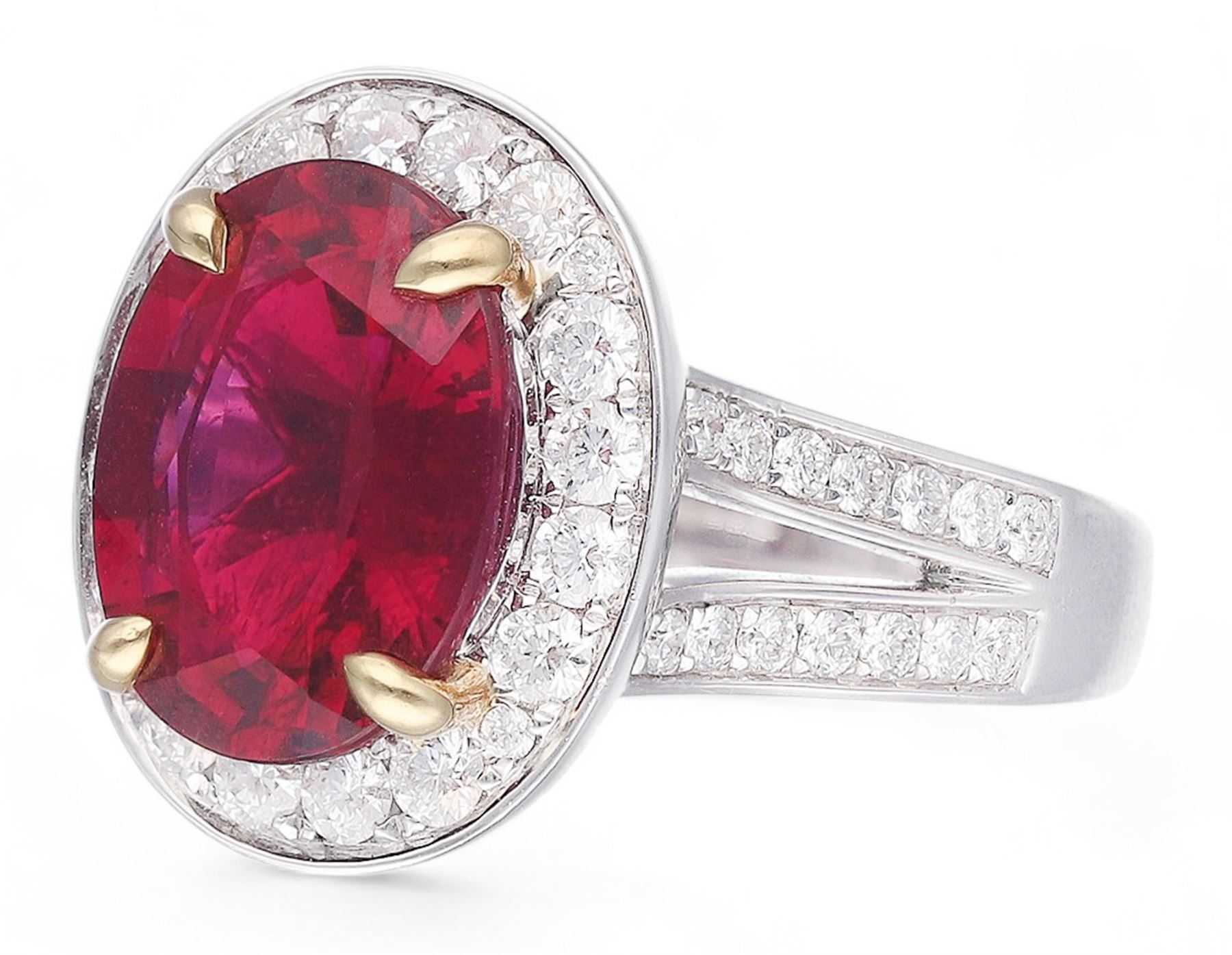 18ct white gold oval cut rubellite tourmaline and round brilliant cut diamond cluster ring, with diamond set shoulders, hallmarked, rubellite 3.93 carat, total diamond weight 0.86 carat 