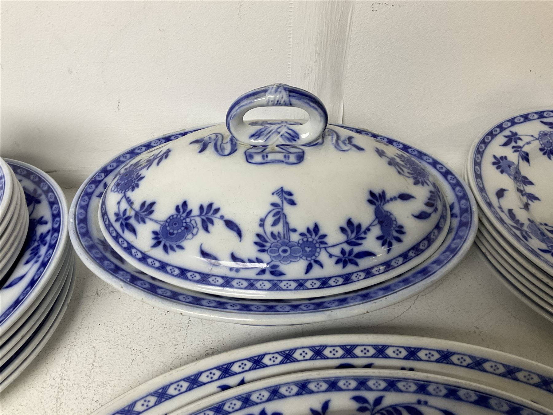 Mintons Delft blue and white dinner wares, to include three graduating oval platters, six dinner plates, six dessert plates and six side plates, tureen with cover and two sauce boats