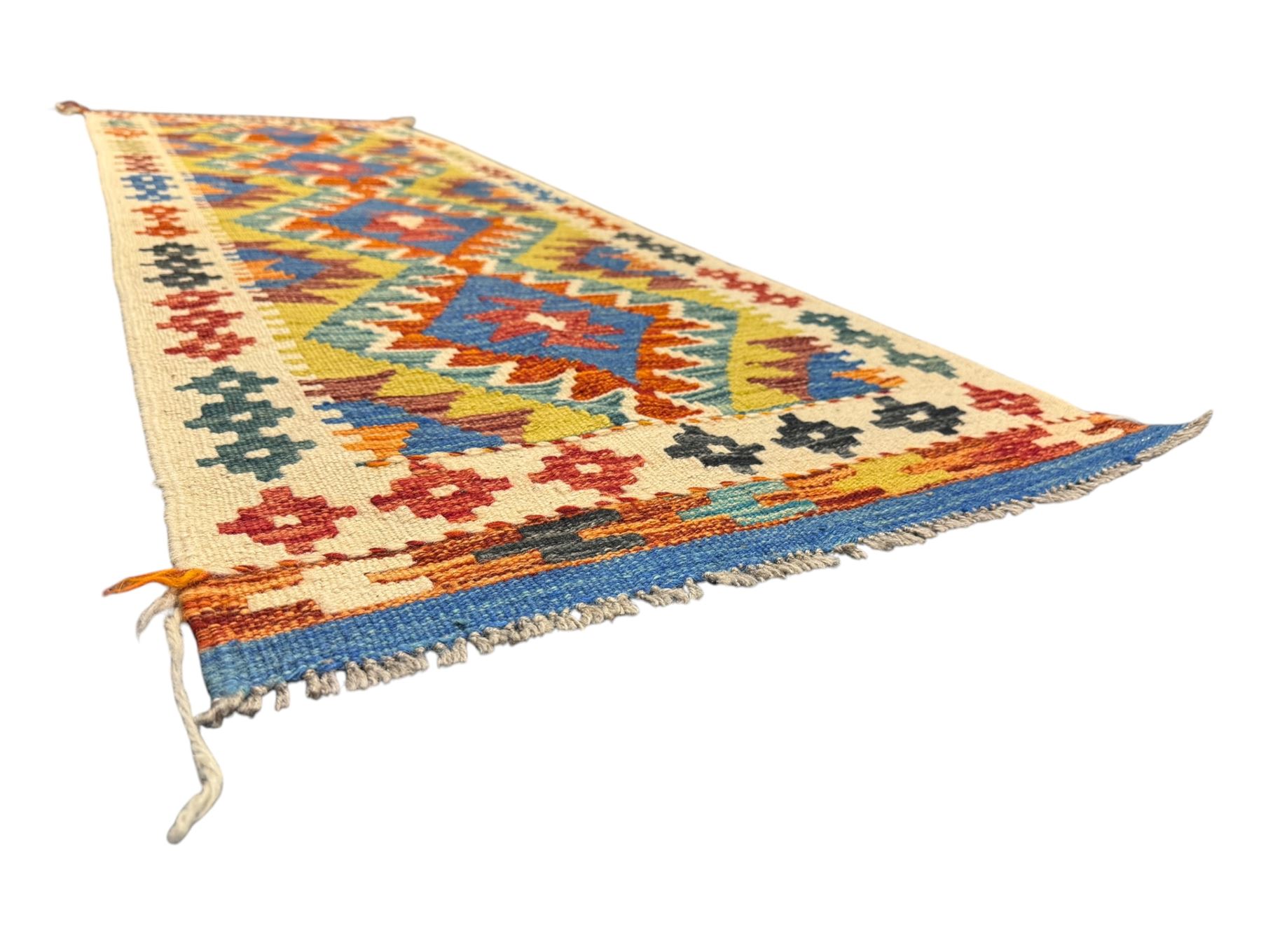 Kilim runner rug, central field decorated with four stacked geometric medallions in a multicoloured zigzag design, bordered by a series of small geometric motifs, fringed edges at both ends