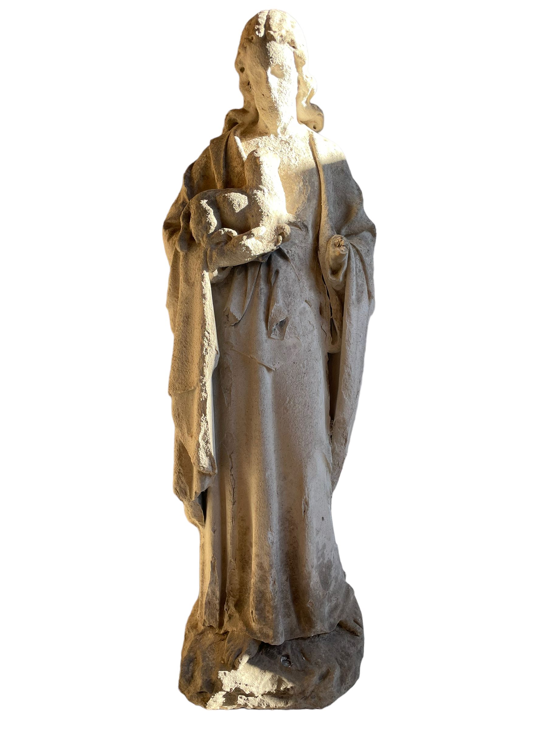 19th century weathered carved sandstone figure of Jesus Christ depicted as the Good Shepherd, draped in robes and holding a lamb, on a naturalistic base