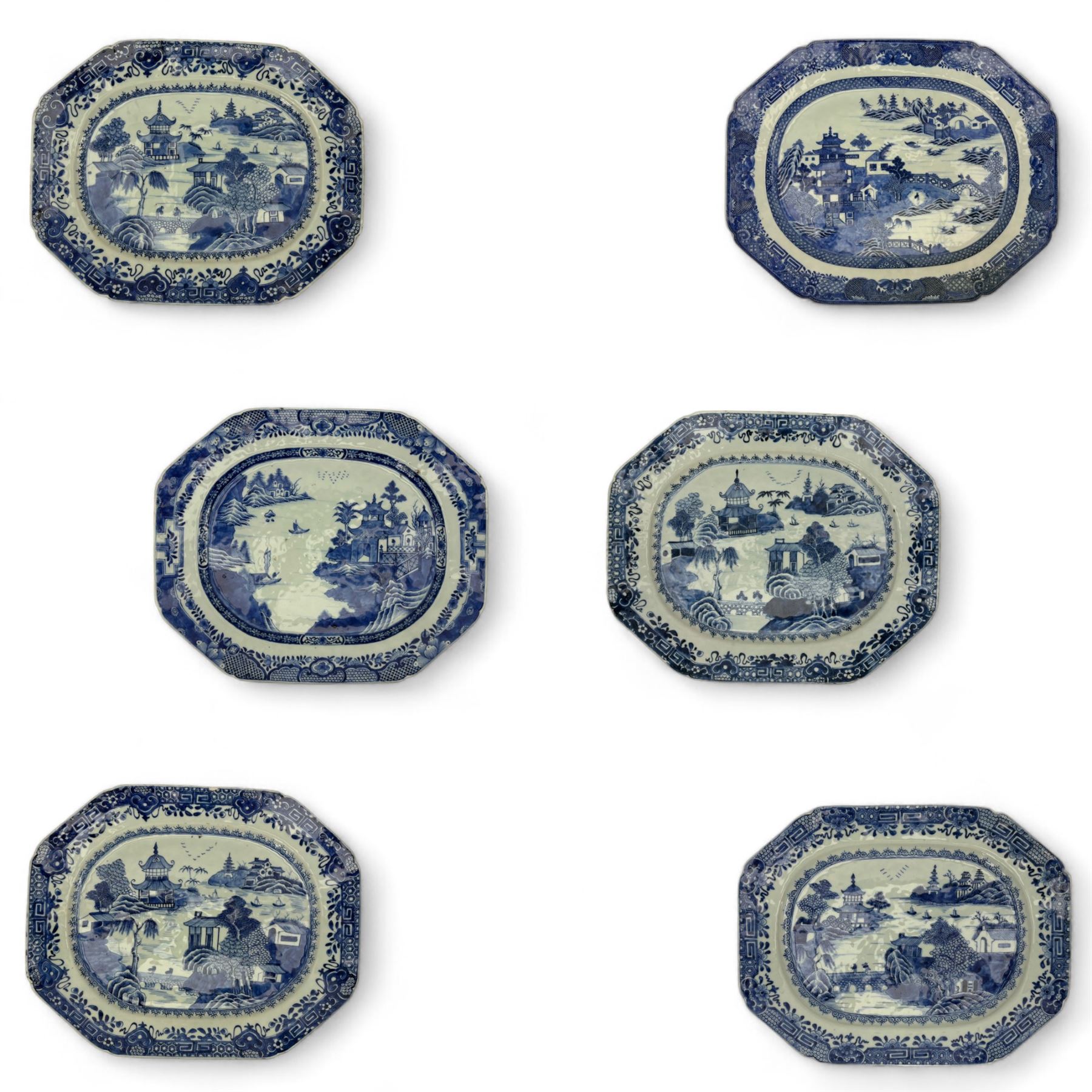 Six 18th century Chinese Export blue and white platters, each of rectangular canted form decorated with various landscape scenes, within foliate borders, max L45cm (6)