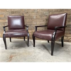 Two rosewood framed armchairs, upholstered in brown leather