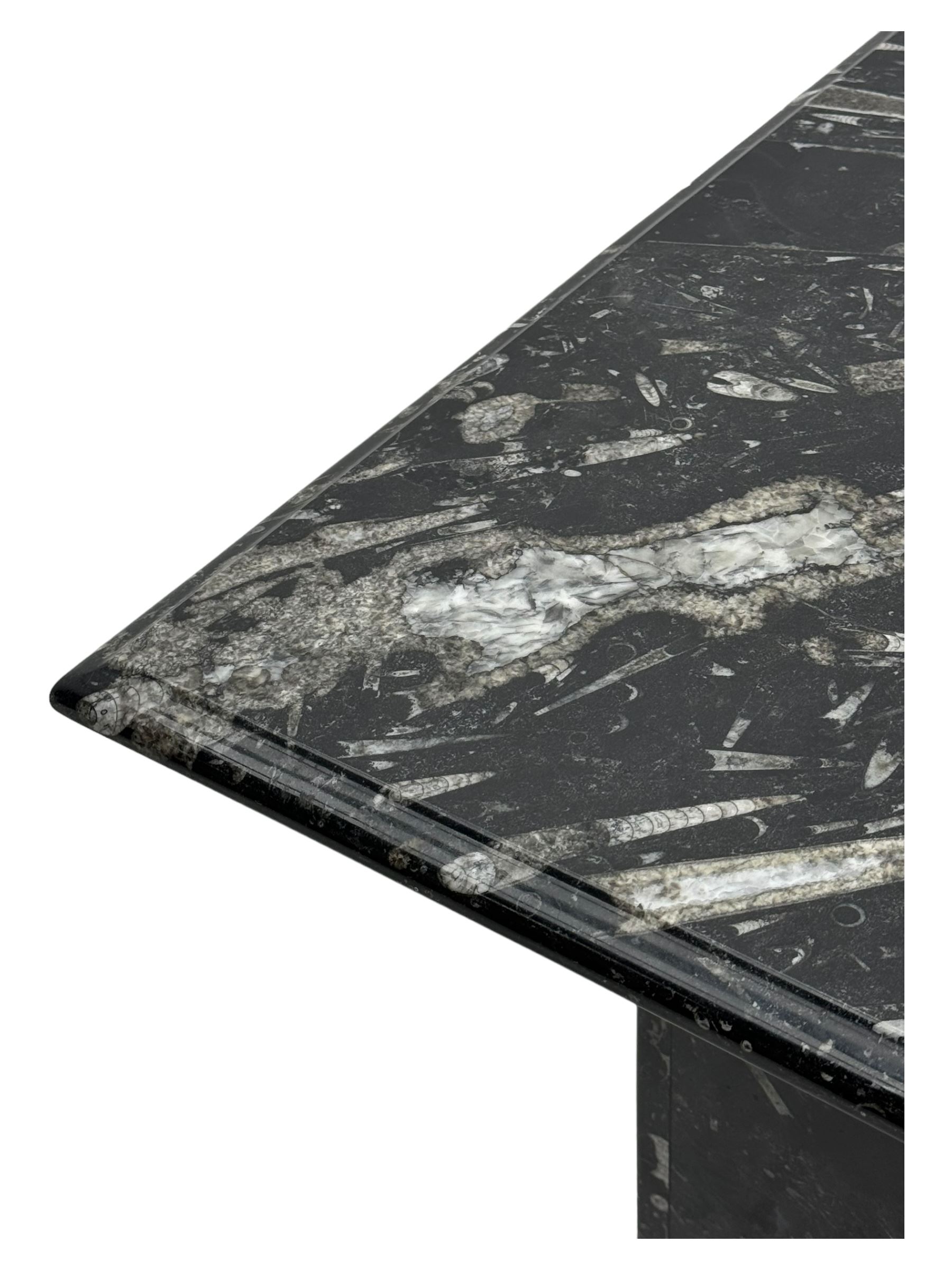 Marble hall table with orthoceras and goniatite inclusions, the rectangular top upon two rectangular stepped plinths, H78cm, L135cm, D77cm