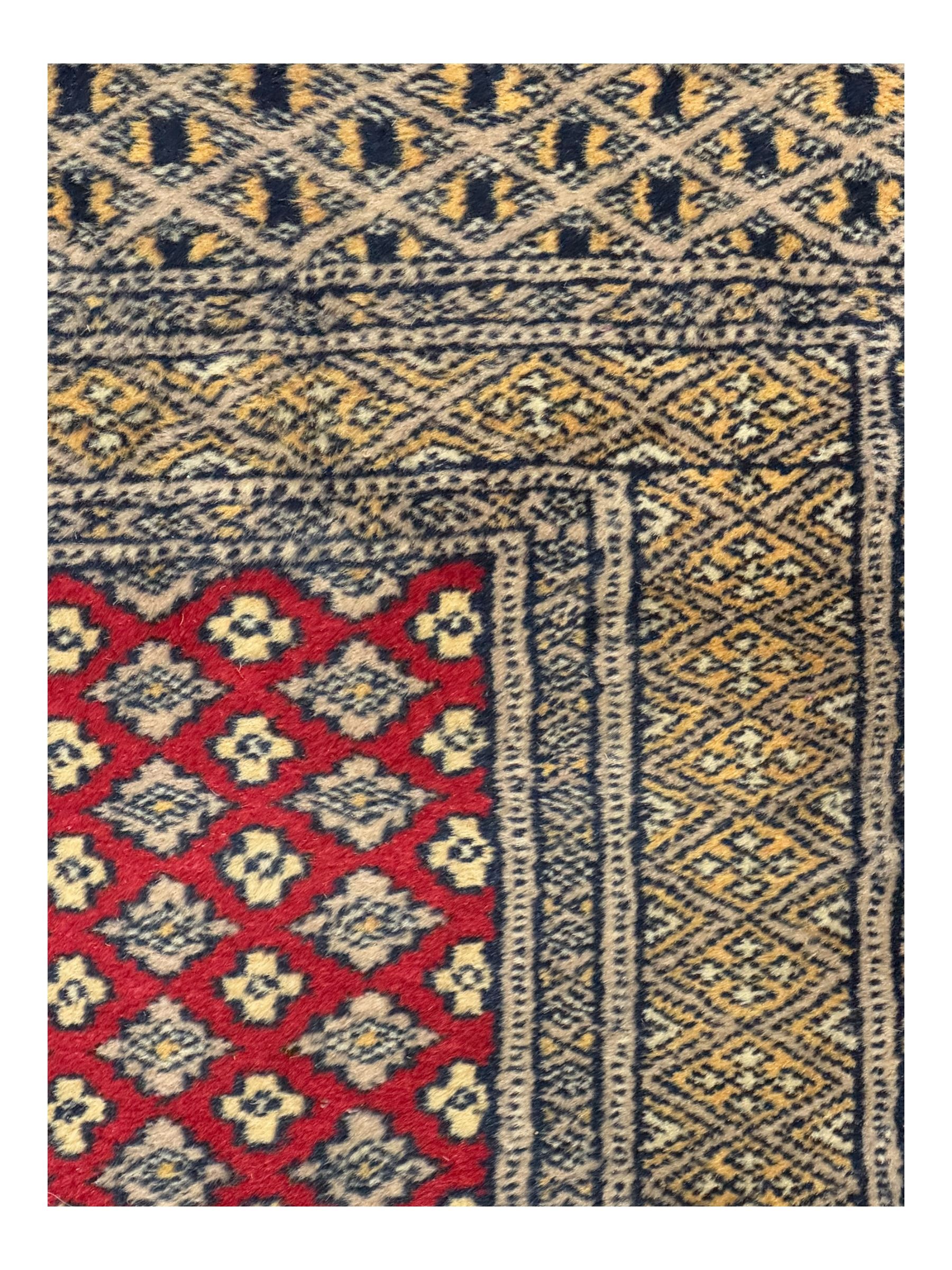 Pakistani Kashan hand-knotted rug with a central medallion and intricate geometric floral patterns, set against a red field and framed by a multi-band border; Pakistani Kashan rug with a repeating floral motif across the red field, enclosed by a detailed geometric border in complementary tones (2)