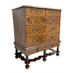 18th century inlaid walnut chest on stand, ovolo-moulded rectangular top inlaid with ebony panels each decorated with scrolling foliage, flower heads and birds, fitted with two short over three long drawers, the drawer fronts decorated with ebony panels enclosing curled leaf inlays, the base fitted with single drawer on turned supports united by waved stretchers, on turned bun feet 