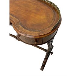 Victorian walnut kidney-shaped writing desk, moulded top with floral cast brass gallery and inset leather writing surface, fitted with three frieze drawers with turned handles, shaped and pierced end supports on raised platforms terminating to splayed feet, united by twist turned and lobe carved stretcher, brass and ceramic castors 