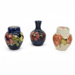 Two small Moorcroft ginger jars in Hibiscus pattern, together with small posy vase in clem...