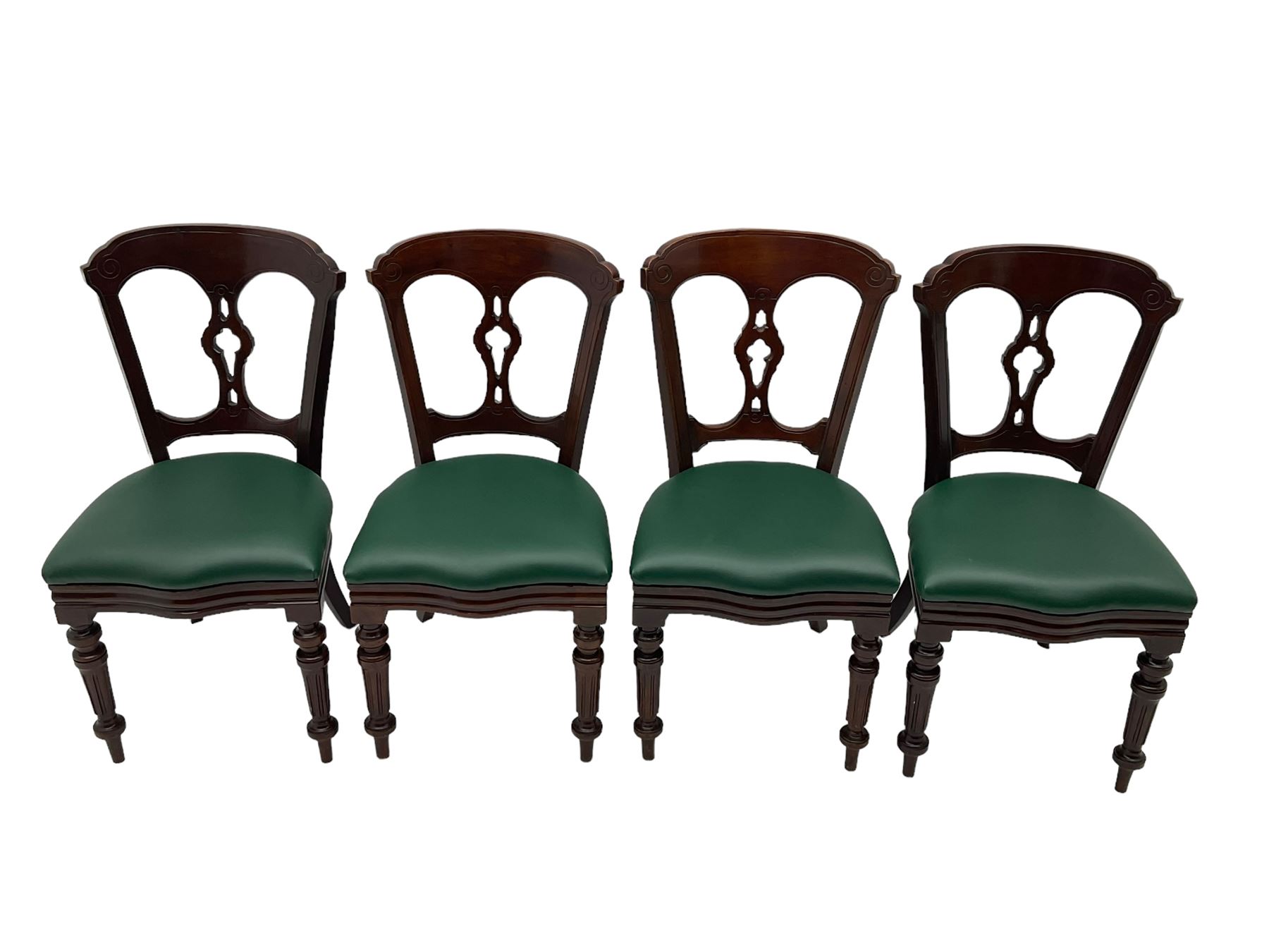 Matched set of twelve Victorian mahogany dining or boardroom chairs, the shaped cresting rail decorated with scrolled decoration, upholstered drop-on seats upholstered in green fabric, on turned supports  