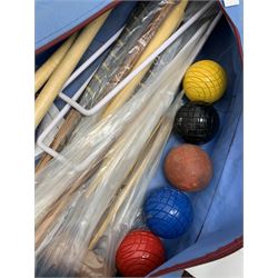 A croquet set, with wooden mallets, hoops, and balls, in carry bag. 