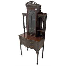 Early 20th century mahogany cabinet on stand, with pierced arched foliate pediment over blind-fretwork frieze, fitted with single astragal glazed door flanked by bevelled mirror back shelves with cluster column uprights, serpentine base fitted with two drawers with blind-fretwork facias 