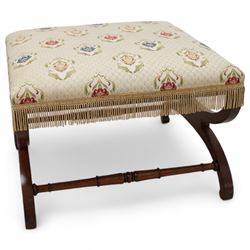 Regency mahogany stool, square seat upholstered in ivory ground floral patterned fabric with gilt thread and fringing, raised on a curved X-framed base united by ring turned supports