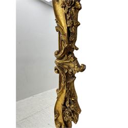 Large gilt framed rectangular wall mirror, shaped and moulded frame decorated with trailing curled acanthus leaves and flower head motifs, bevelled glass plate 