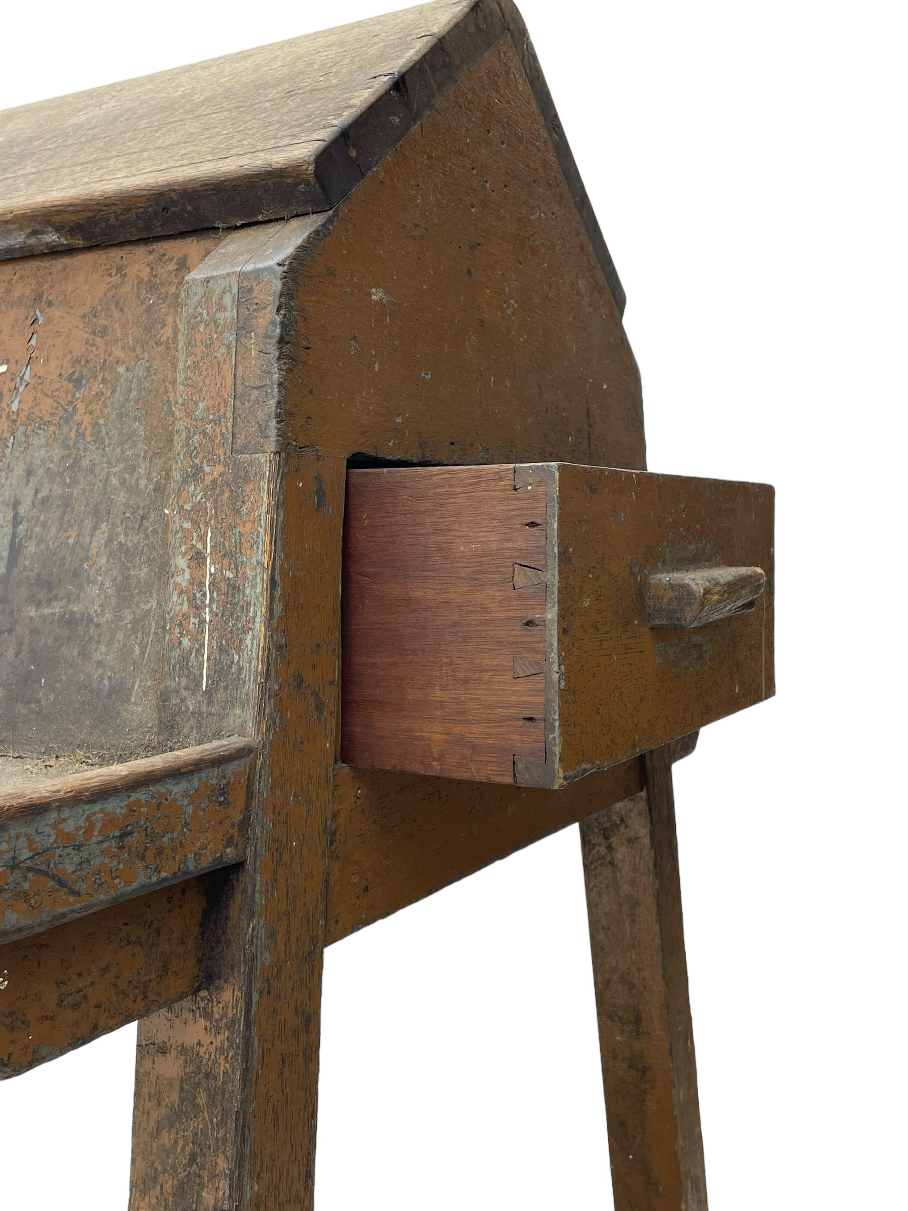 19th century teak saddle horse, A-frame on trestle base, fitted with shelves at either side and end drawers, on square supports united by undertier 