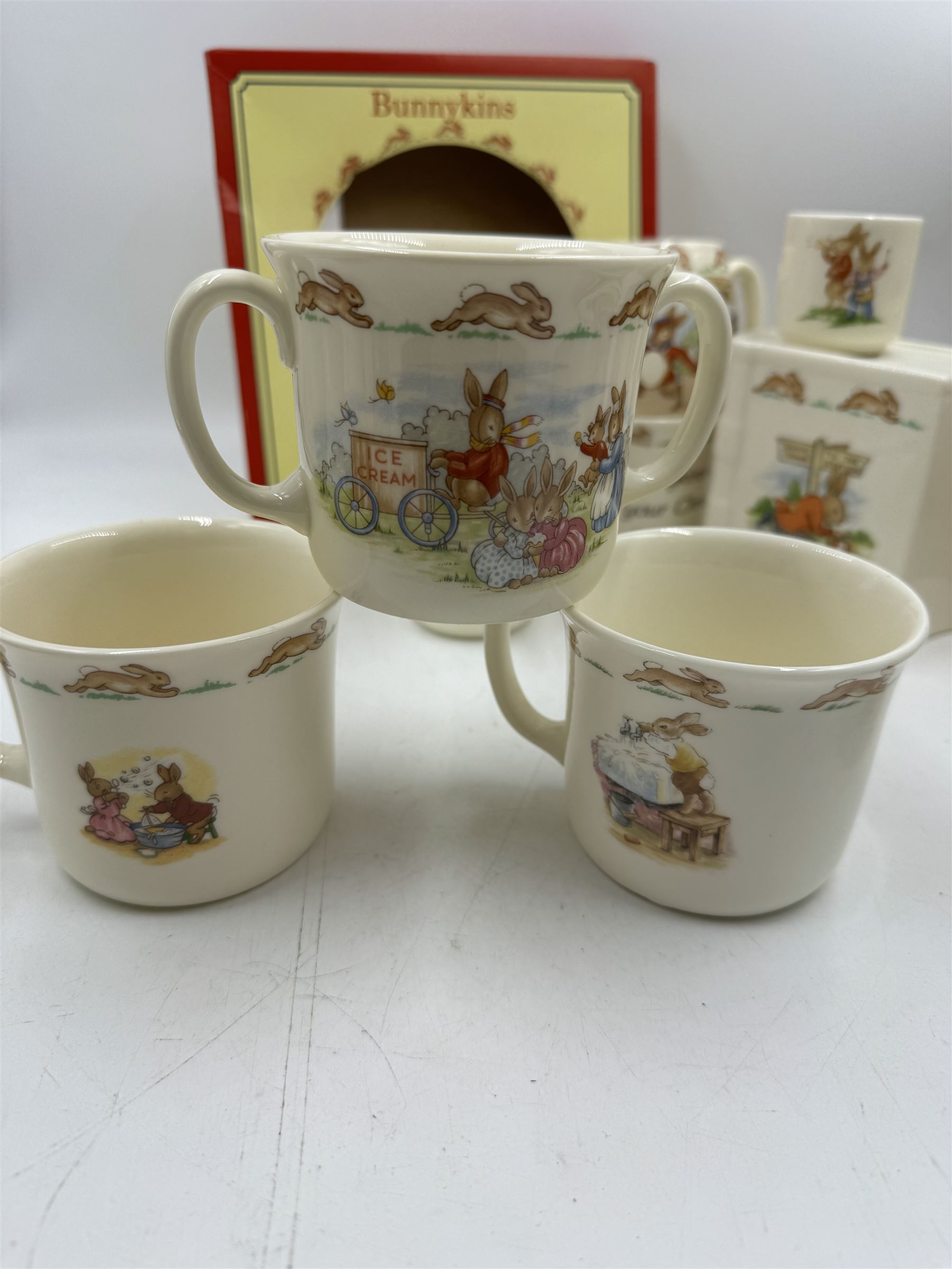 Royal Doulton Bunnykins teawares, including teacups and saucers, egg cup, money boxes etc (12)