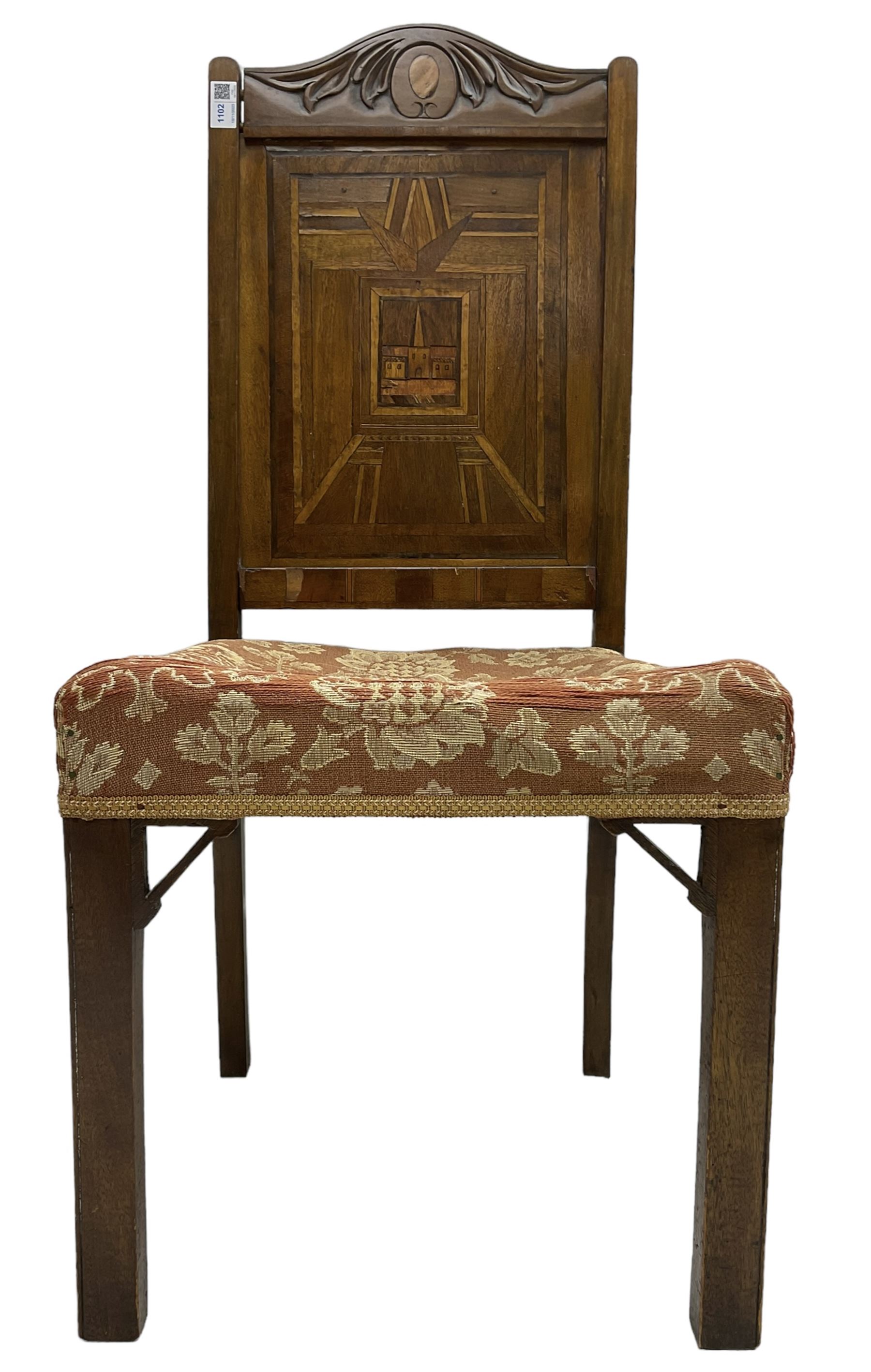 19th century walnut side chair, foliage carved cresting rail over geometric inlaid back with central panel depicting buildings, upholstered seat, on moulded and chamfered square supports