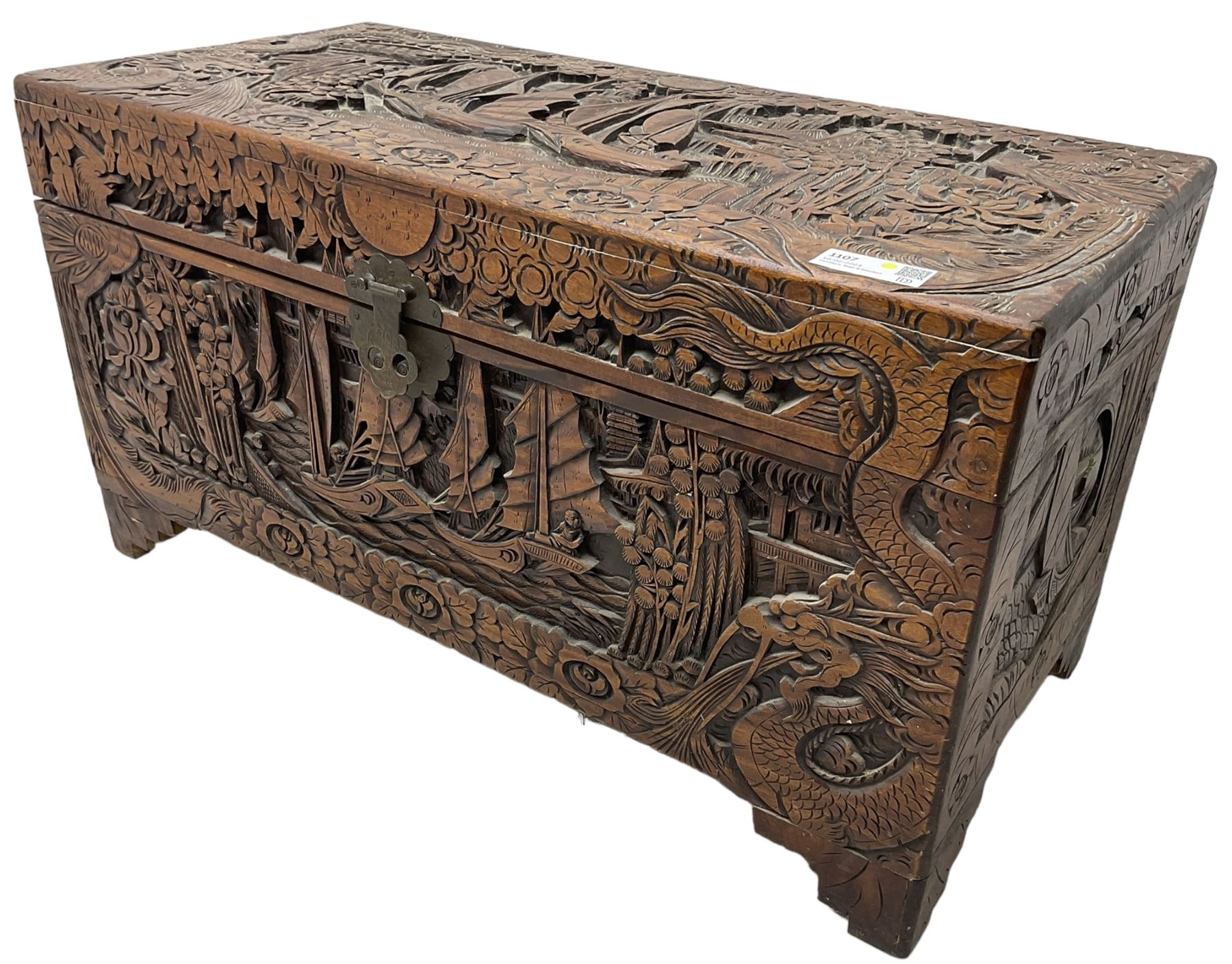 Chinese carved camphor wood blanked chest, rectangular hinged top, carved all over with traditional dragon motifs and junk ships