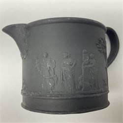 Late 19th/early 20th century Wedgwood black basalt three piece tea set, comprising teapot, sucirer and cover, and milk jug, each of cylindrical form, decorated with a vignette of classical maidens, each impressed beneath Wedgwood, Made in England, teapot H10cm