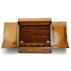 Edwardian oak correspondence box, the hinged sloping front enclosing a fitted interior incorporating a stationery rack, perpetual calendar, pen tray and two glass inkwells, H32cm x W40cm