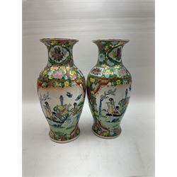 Pair of Famille Rose vases of baluster form, decorated with panels depicting musicians, H30cm