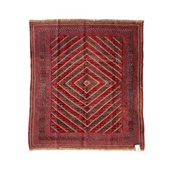 Meshwani indigo and maroon ground rug, the field decorated with a central lozenge with con...