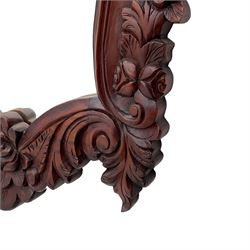 Pair of carved hardwood wall mirrors, shaped floral carved pediment over trailing and scrolled foliage decoration, plain mirror plate 