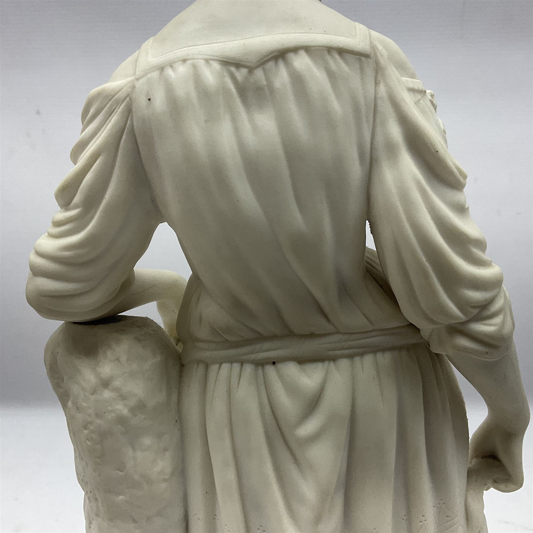 Parian figure modelled as a female in classical dress leaning upon a tree stump, H36cm