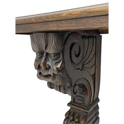 Victorian oak bench, moulded rectangular top, on mask and scroll carved corbel supports with paw feet, rectangular platforms with rounded terminals and applied roundel 