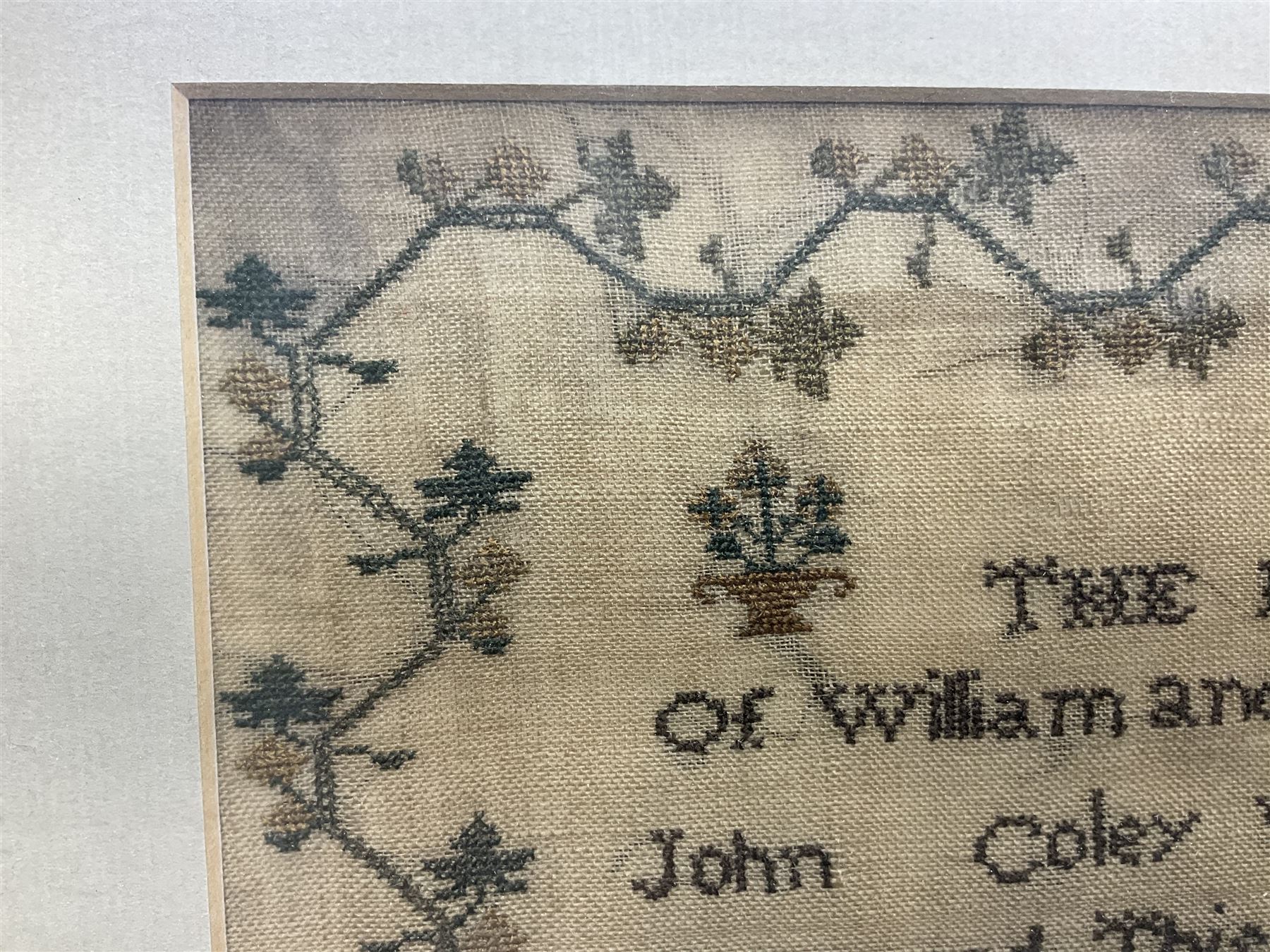 William IV needlework sampler by Ann Coley aged 8 years, dated 1835, embroidered with 'The Register of William and Alice Coley's Children' in a floral border, framed, frame H45cm