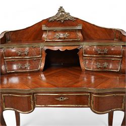 Early 20th century Louis XV design Kingwood and ormolu mounted bonheur du jour, shaped raised back fitted with five drawers and central recess, surmounted by scrolling foliate casting and pierced gallery, single frieze drawer with sliding top inset with crushed velvet, on cabriole supports mounted by mask castings with extending floral decoration, the sides and drawer fronts inlaid with parquetry panels 