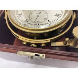 Two-day marine chronometer, with silvered dial inscribed Thomas Mercer Ltd, St Albans, contained within a brass gimbal-mounted bowl and glazed mahogany case, with applied brass plaque reading 'supplied by Kelvin Hughes no. 24295', brass winding key and two service notes to interior of case, dial D12cm, wooden case H17.5cm 