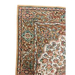 Large Persian design carpet, overall floral design, the field decorated with large rosette motifs surrounded by trailing foliate motifs, the border decorated with trailing branch and stylised plant motifs