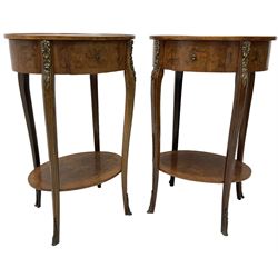 Pair of early 20th century French walnut bedside stands, oval bookmatched and cross-banded top fitted with single drawer, raised on cabriole supports united by undertier, decorated with floral gilt metal mounts