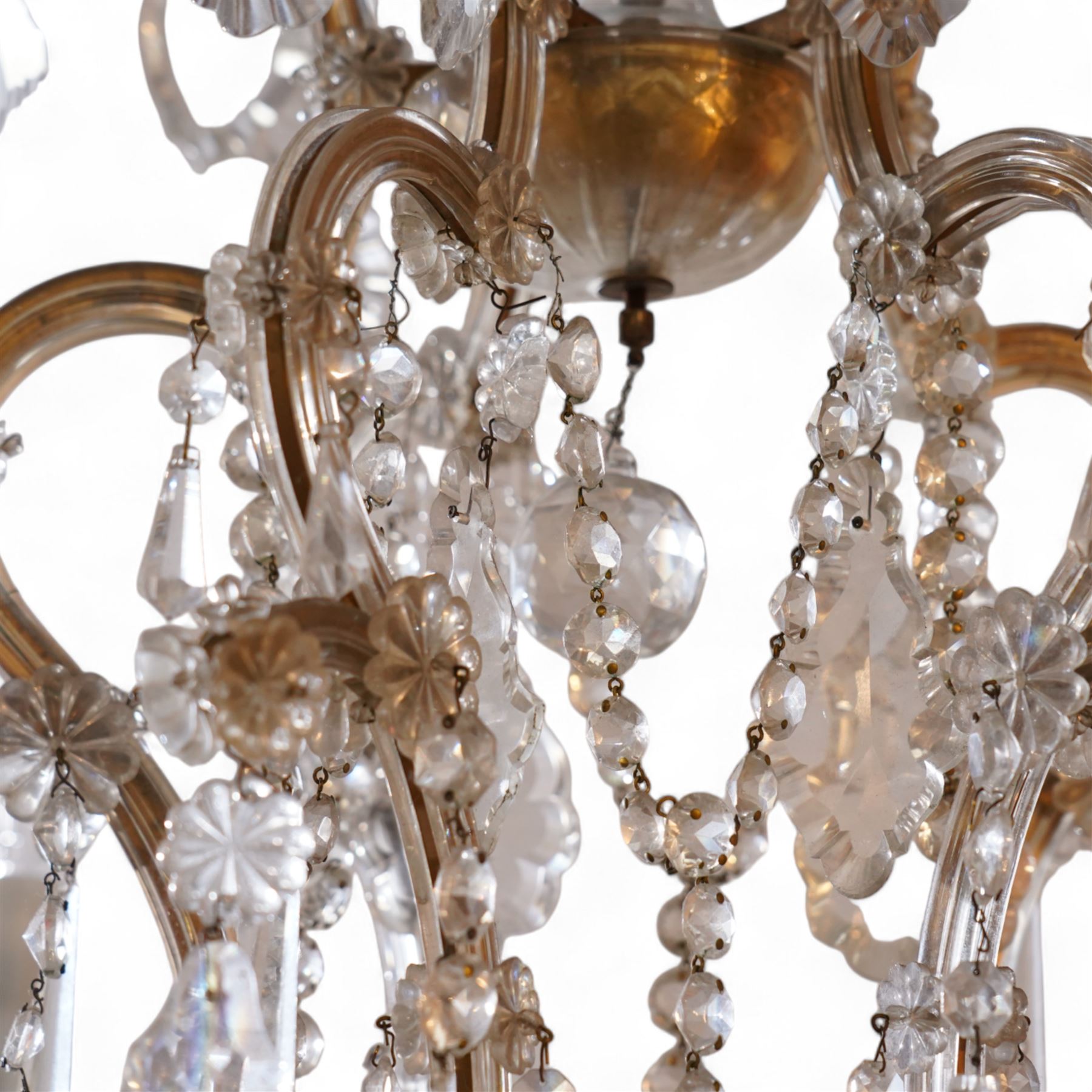 Large mid-to-late 20th century two-tier glass chandelier, shaped body dish over glass column, serpentine metal frame supporting fifteen branches, the frame clad with glass panels and decorated with drop pendants, each branch with glass bobeche decorated with drop prisms 