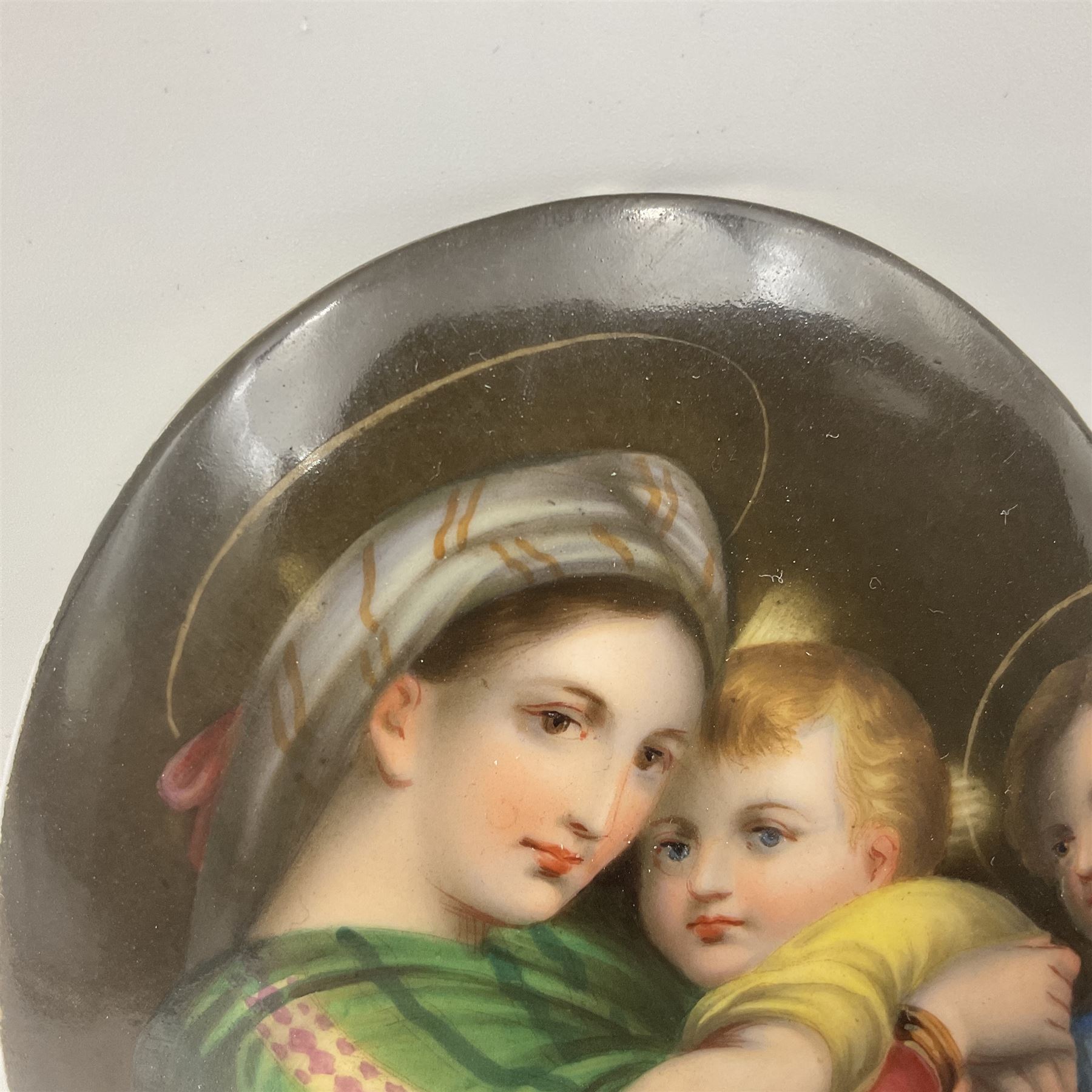 19th century Continental porcelain plaque, of oval form, painted with the Madonna and Child after Raphael, unmarked, possibly KPM, H12cm W9cm 