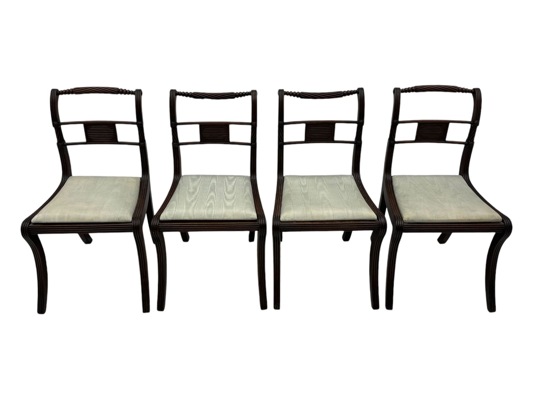 Set of four Regency mahogany dining chairs, rope twist and bead turned cresting rail over reeded middle rail, upholstered drop-in seat, reeded frame and sabre supports