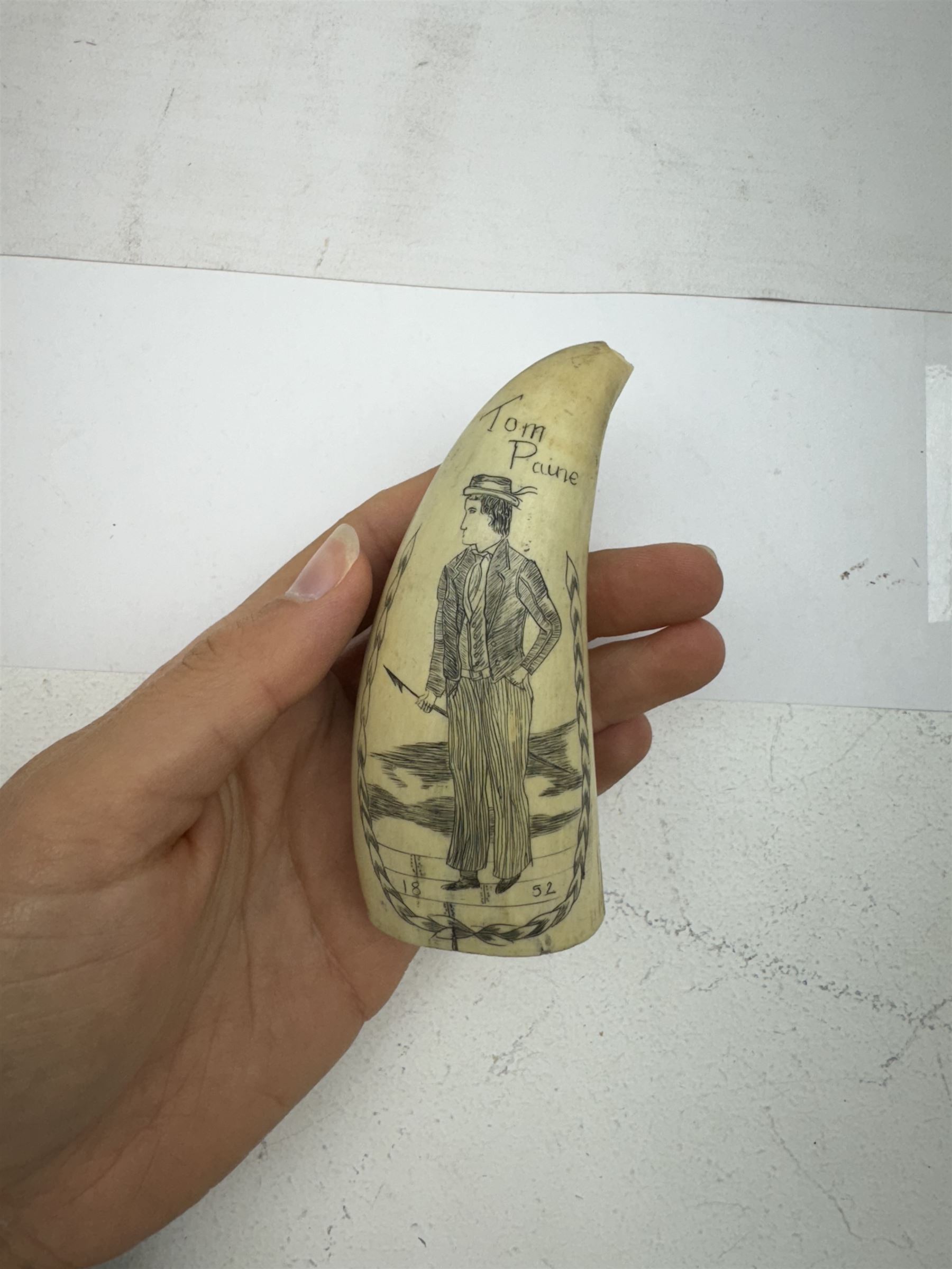 Two 19th century scrimshaw whale tooth, the first depicting a erotic scene, the second depicting Tom Paine, largest L11cm 