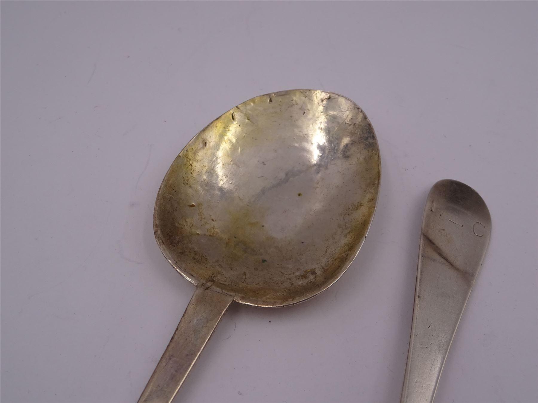 17th century silver trifid spoon, marks worn and indistinct, together with an Old English pattern silver spoon