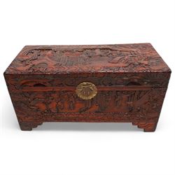 Chinese heavily carved and lacquered camphor wood blanket chest, rectangular hinged top, carved all-over with traditional figural and pagoda scenes with exotic birds, enclosed by a border of stylised clouds