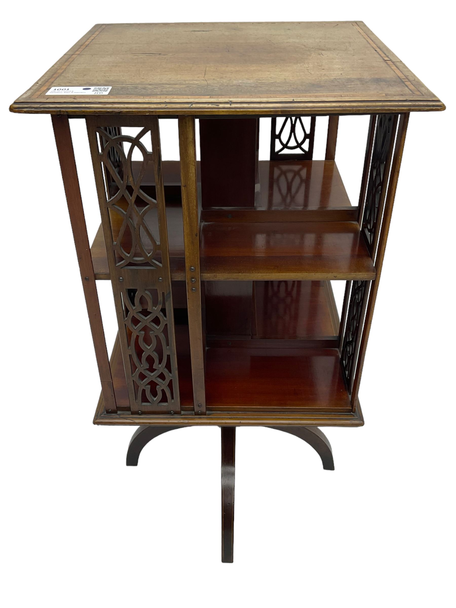 Edwardian mahogany revolving bookcase, square moulded top with satinwood band, two tiers with pierced vertical splats, on four curved supports 