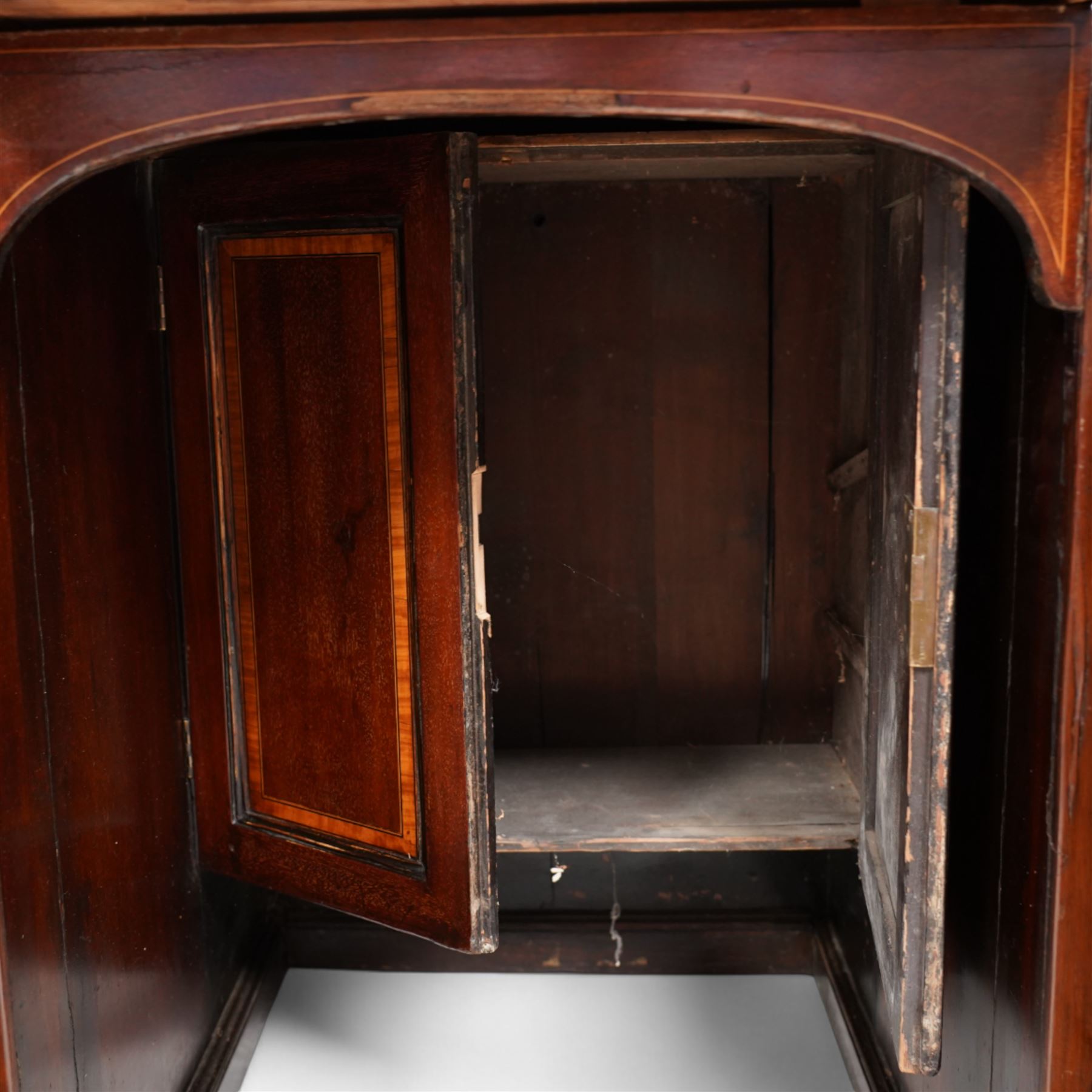 19th century inlaid mahogany kneehole desk, moulded rectangular top with inset leather writing surface and satinwood band, one side fitted with eleven drawers and panelled cupboard, the opposing side with kneehole fitted with eleven drawers and double cupboard, on skirted base with moulded edge 