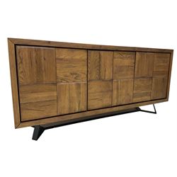 Samba 'Camden' oak sideboard, rectangular top over three block panelled cupboard doors, raised on angled black metal supports connected with stretcher