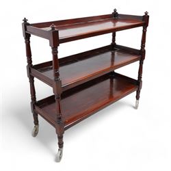 Victorian mahogany three-tier buffet, raised three-quarter gallery back with surmounted turned finials and moulded front edge, raised on turned supports and uprights terminating to castors