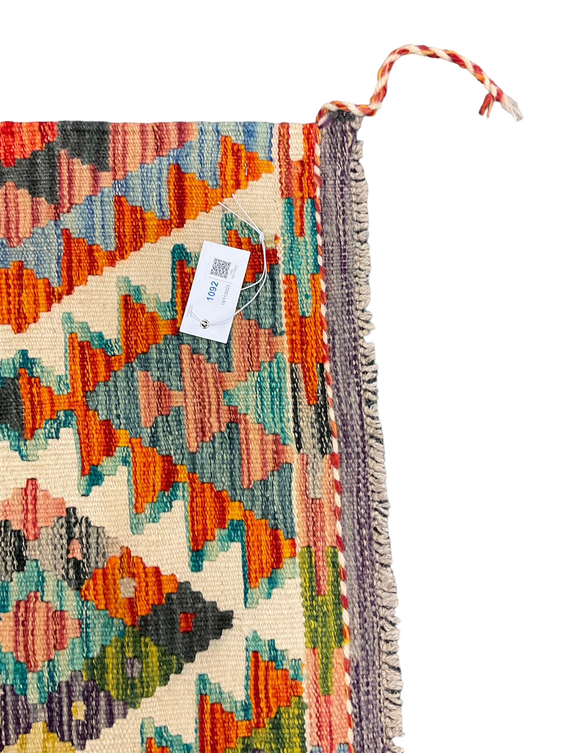 Chobi Kilim rug, over geometric design, decorated with multi-coloured stepped lozenges