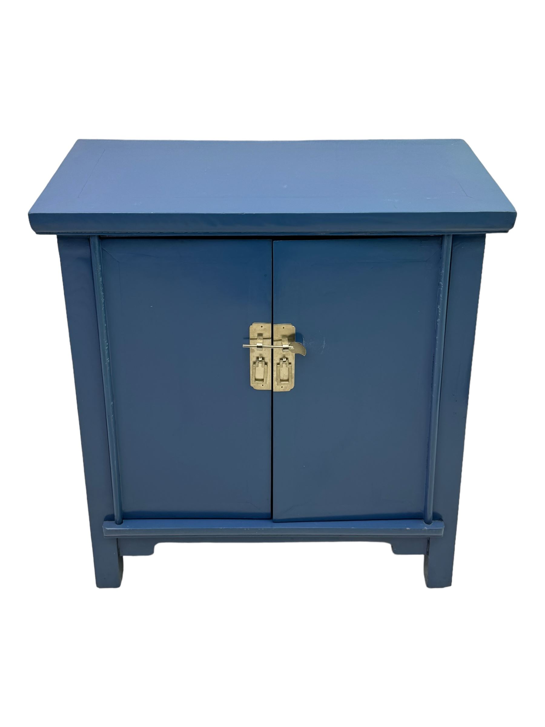 20th century Chinese blue lacquered cabinet, rectangular top over double doors with brass latch, interior fitted with shelves, on square supports