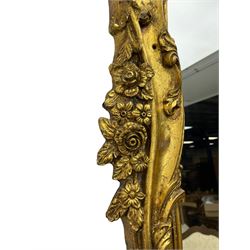 Large gilt framed rectangular wall mirror, shaped and moulded frame decorated with trailing curled acanthus leaves and flower head motifs, bevelled glass plate 